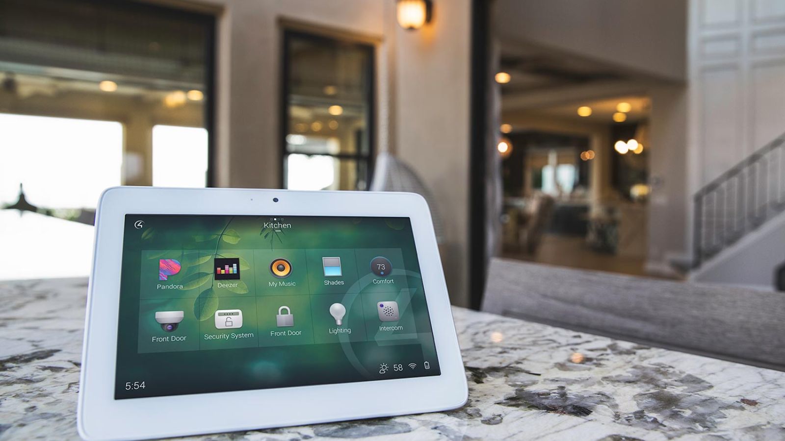 Control4 Touch panel in a able with a traditional home in the background