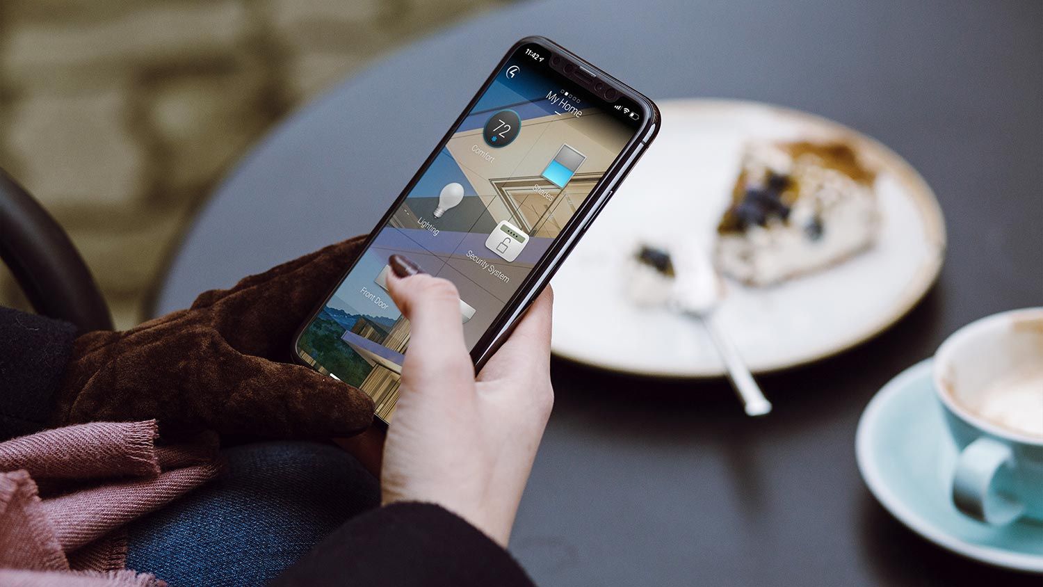 Person holding iphone with Control4 interface on it